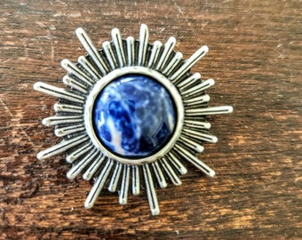 Broche Sunburst bleue et argentée.