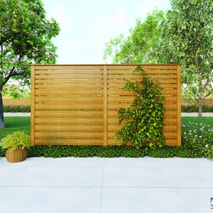 May include: A wooden privacy fence with horizontal slats, featuring a climbing vine growing up the side. The fence is in a backyard setting with green grass and plants.