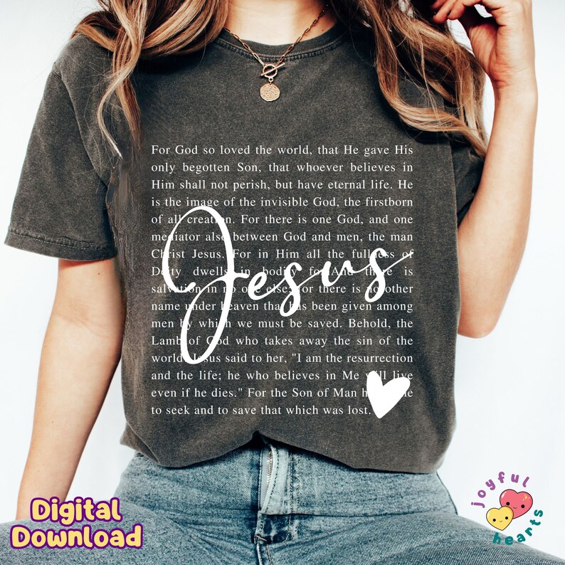 May include: A dark gray t-shirt with a white print of a Bible verse about Jesus. The text reads "For God so loved the world, that He gave His only begotten Son, that whoever believes in Him shall not perish, but have eternal life. He is the image of the invisible God, the firstborn of all creation. For there is one God, and one mediator also between God and men, the man Christ Jesus. For in Him all the fullness of Deity dwells in bodily form. And He is the salvation in no other, for there is no other name under heaven that has been given among men by which we must be saved. Behold, the Lamb of God who takes away the sin of the world Jesus said to her, "I am the resurrection and the life; he who believes in Me will live even if he dies." For the Son of Man has come to seek and to save that which was lost."