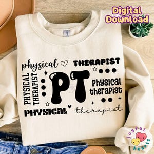 May include: A cream-colored sweatshirt with black text that reads "physical therapist" and "PT" in a large, stylized font. The text is repeated in different variations.