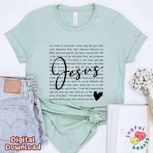 May include: A light green t-shirt with a black print of a Bible verse about Jesus. The text includes the words "For God so loved the world" and "Jesus".