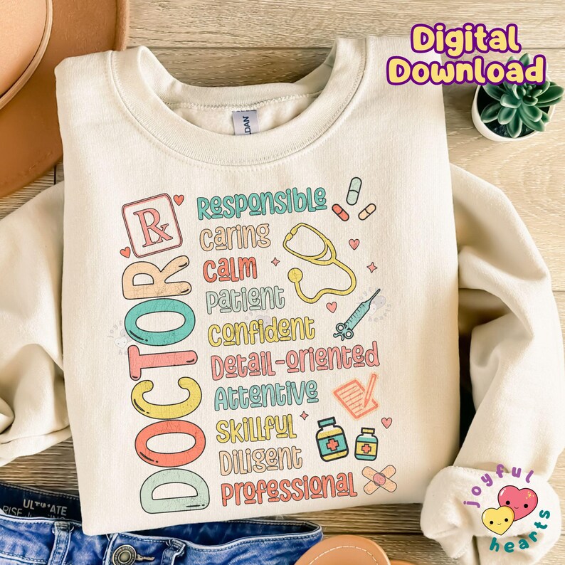 May include: A cream-coloured sweatshirt with a colourful graphic design that reads "DOCTOR" and lists positive attributes of a doctor, such as "responsible", "caring", "calm", "patient", "confident", "detail-oriented", "attentive", "skillful", "diligent", and "professional".