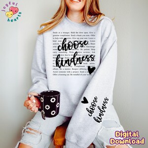 May include: Gray sweatshirt with the text "choose kindness" printed on the front. The text is in black and is surrounded by a heart. The sweatshirt is being worn by a person.