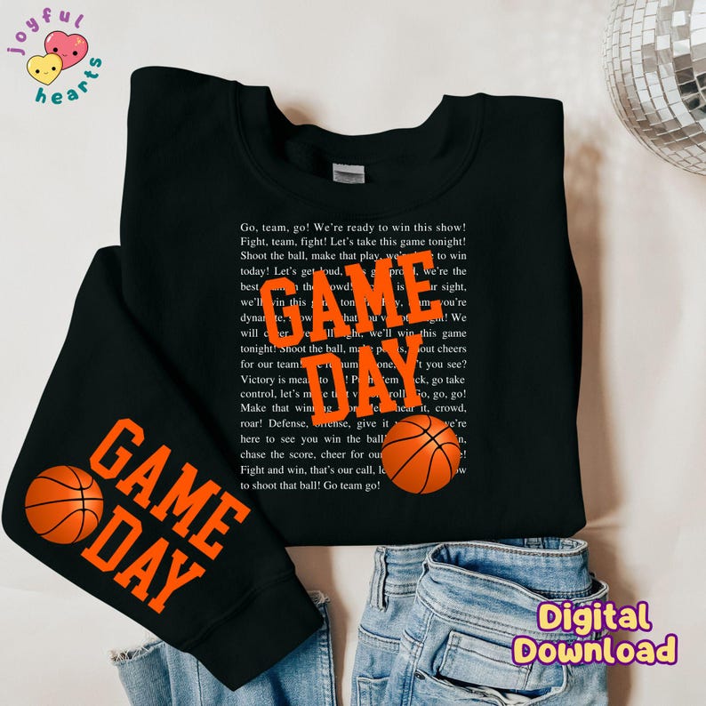May include: Black sweatshirt with orange text that reads "GAME DAY" and a basketball graphic. The text says "Go, team, go! We're ready to win this show! Fight, team, fight! Let's take this game tonight! Shoot the ball, make that play, we're the best today! Let's get loud, we'll win this game tonight! Shoot the ball, make that play, we'll win this game tonight!"