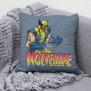 May include: A blue throw pillow with a graphic of Wolverine, a comic book superhero, with the word "Wolverine" in yellow, red, and orange letters.