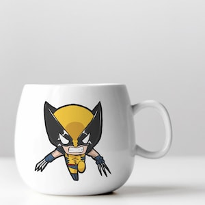 May include: White ceramic mug with a cartoon image of Wolverine, a superhero with yellow and black costume, claws, and a fierce expression.