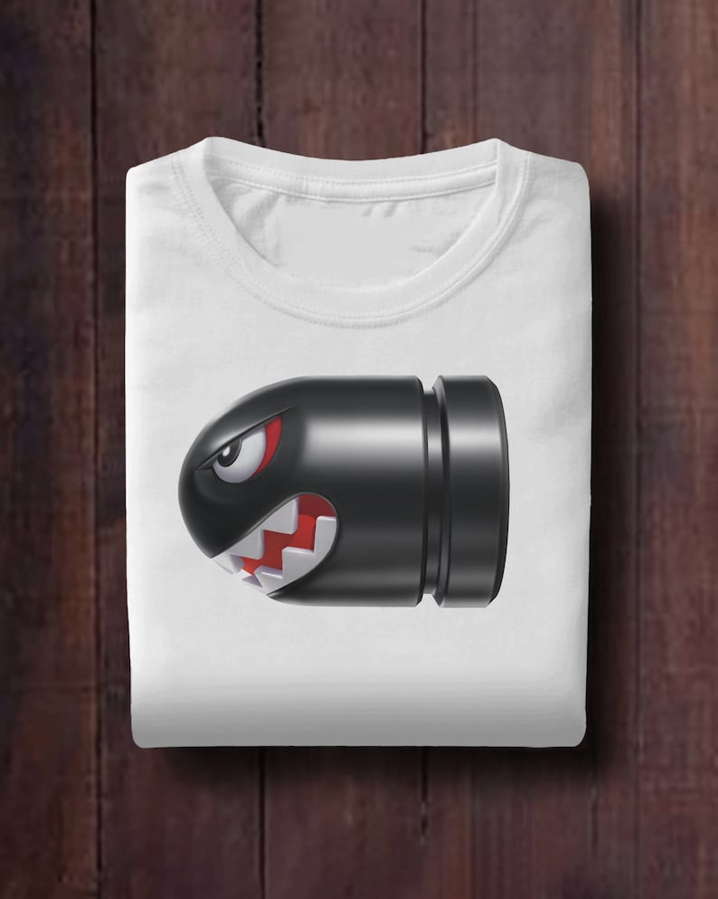 May include: White t-shirt with a black and red cartoon bullet bill character from the Super Mario video game series.