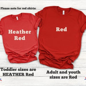 May include: Two red t-shirts, one labeled "Heather Red" and the other "Red." Text at the bottom indicates toddler sizes are "Heather Red" and adult/youth sizes are "Red."