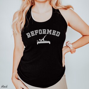 May include: Black tank top with the text "REFORMED" in white, featuring a white silhouette of a person doing a Pilates exercise on a reformer.