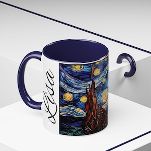 May include: A white ceramic mug with a navy blue rim and handle. The mug features a colorful stained glass style image of Vincent van Gogh's "Starry Night" painting. The name "Lisa" is written in cursive on the left side of the mug.