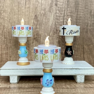 May include: A set of three ceramic mugs with a speckled, matte finish. The mugs are in shades of cream, light gray, and dark gray. Each mug has a simple, minimalist design and a rounded handle.
