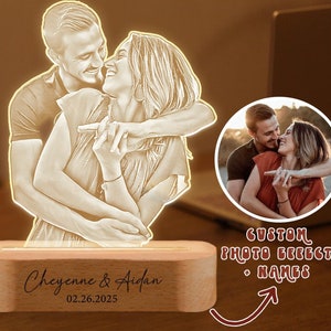 May include: A custom photo night light with a wooden base. The light features a couple embracing, with their names "Cheyenne & Aidan" and the date "02.26.2025" engraved on the base.
