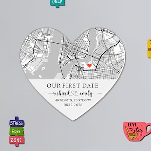 May include: A heart-shaped map with the text "OUR FIRST DATE" and the names "richard & emily". Coordinates and a date are also included. The map is gray and white with a red heart marking a location. Surrounding magnets say "FOOD VIBES ONLY", "STRESS FREE ZONE", and "LOVE to stir THINGS UP".