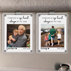 May include: Two rectangular photo visor clips. Each clip has a photo and text. The left clip says "Forever in my heart, always by my side" with a photo of a man and child. The right clip says the same with a photo of a man and two children.