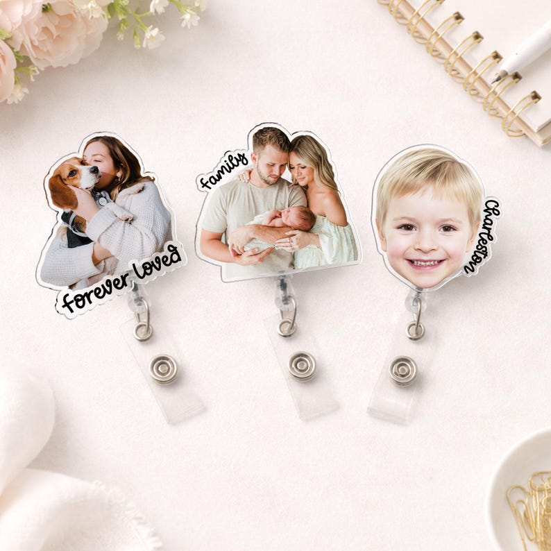 May include: Three clear acrylic badge reels with personalized photos. One features a woman with a dog, the text "forever loved". Another shows a family with the text "family". The last one has a child's photo with the name "Charleston".