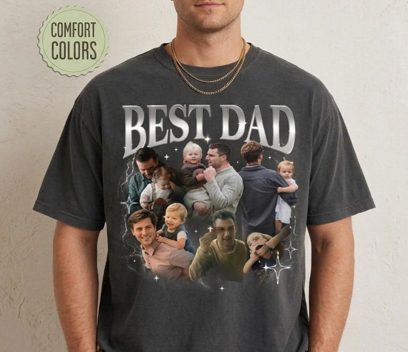 May include: Dark gray t-shirt with the text "BEST DAD" in a silver, retro-style font. The shirt features a collage of photos of fathers with their children. The words "COMFORT COLORS" are in a green circle.