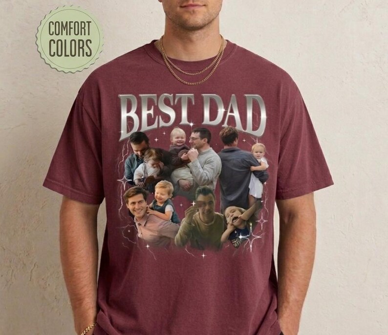 May include: Burgundy t-shirt with the text "BEST DAD" in a silver, retro font. The shirt features a collage of photos of a man with children. The words "COMFORT COLORS" are in a green circle.