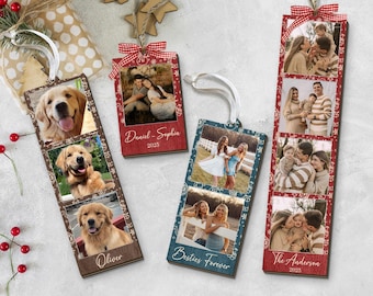 May include: Wooden photo ornaments with family photos, featuring red and blue frames, white ribbons, and decorative patterns. One ornament displays photos of a golden retriever, with the name "Oliver" at the bottom. Other ornaments have family photos and text.
