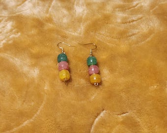 May include: A pair of gold earrings with three beads each. The beads are green, pink, and yellow.