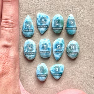 May include: Ten different sizes of blue and green gemstone cabochons, labeled with letters A through J. Each cabochon has a unique pattern and is measured in millimeters.