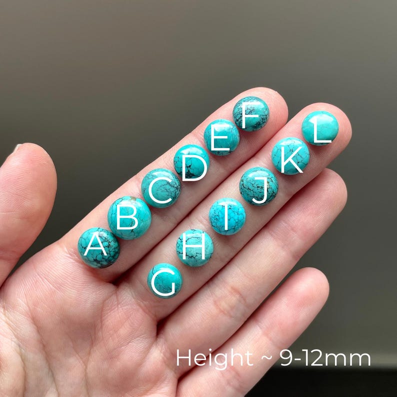 May include: Turquoise cabochons, labeled A through L, are arranged in a row on a hand. The cabochons are approximately 9-12mm in height.