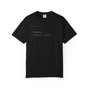 May include: A black short-sleeve t-shirt featuring white, blue, and red HTML code text printed on the front. The code includes the text DOCTYPE html, html, body, h1 EDDesignbyJenn, and p I'm reaching my breaking point, followed by closing tags.