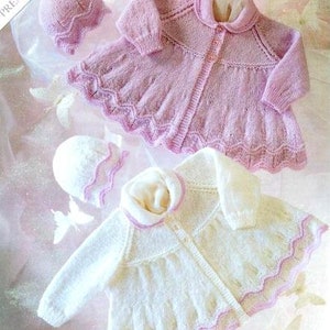 May include: Two knitted baby jackets with matching hats. The jackets are pink and white with a scalloped edge and button closures. The hats are pink and white with a scalloped edge.