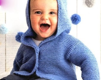 May include: A baby wearing a blue knitted hooded cardigan with a button closure. The cardigan is made with a soft, textured yarn.