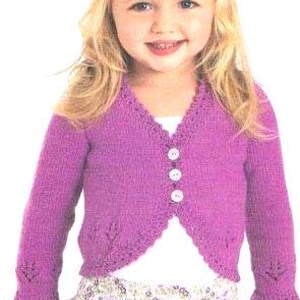 May include: A purple knitted cardigan with a V-neck and button closure. The cardigan has a delicate lace pattern on the sleeves and neckline.