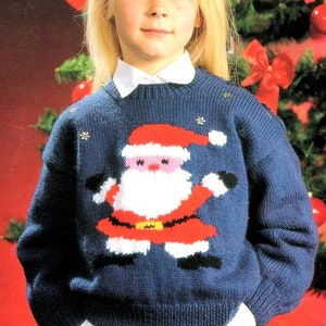 May include: A blue knitted jumper with a Santa Claus design. The jumper has a white collar and is decorated with silver snowflakes.