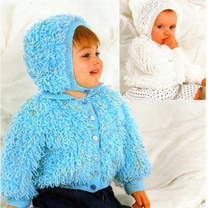 May include: A blue knitted baby cardigan with a hood and button closure. The cardigan has a fluffy texture and is made with a light blue yarn. The baby is wearing blue jeans.