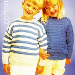 May include: Two children wearing knitted sweaters. One sweater is blue and white striped, the other is solid blue. The word "cotton" is printed vertically on the left side of the image. Both children are smiling.