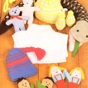 May include: Knitting pattern for a variety of items, including a teapot cozy, a doll, a bear, a hat, mittens, and a sweater. The pattern is called "Jarol" and the number is "JX116 DK".