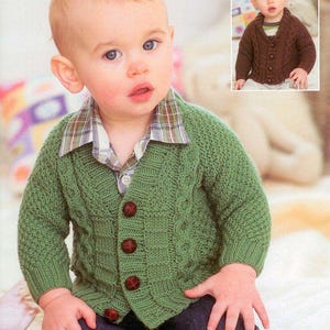 May include: A baby in a green knitted cardigan with a plaid collar and dark buttons. The image includes the text "SNUGGLY DK" and "SIRDAR". A smaller image shows a similar brown cardigan. The baby is wearing dark blue jeans.