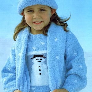 May include: A blue knitted jumper with a white snowman design and a matching blue scarf and hat. The jumper has a snowflake pattern.