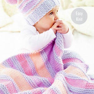 May include: A baby wearing a striped knitted hat with a pom-pom and wrapped in a matching knitted blanket. The blanket and hat feature pink, lavender, and peach stripes. The word "chunky" is in the top right corner, and "Easy Knit" is in a circle.
