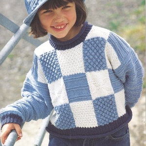 May include: A blue and white checkered knit sweater with a blue knit collar and cuffs. The sweater has a textured pattern on some of the squares.