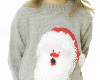 May include: A light gray knitted sweater featuring a large Santa Claus face on the front. The Santa design includes a white beard, red hat, and a small red nose. The sweater is a festive holiday garment.