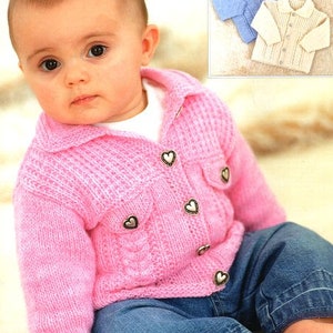 May include: A pink knitted baby cardigan with a button-up front and silver heart-shaped buttons. The cardigan has a collar and is worn by a baby with blue jeans.