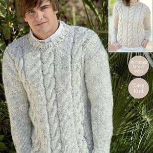 May include: A white cable knit sweater with a crew neck. The sweater is made with a chunky yarn and has a relaxed fit. The sweater is shown on a model wearing it with jeans.