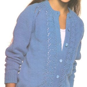 May include: A light blue knitted cardigan with a button-up front and a lace pattern on the front and sleeves.