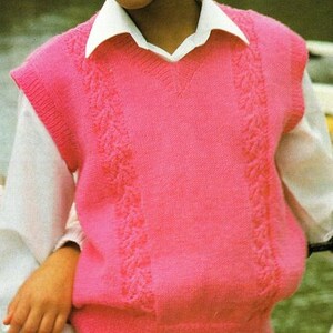 May include: A pink knitted sleeveless sweater vest with a cable knit pattern on the front and sides.