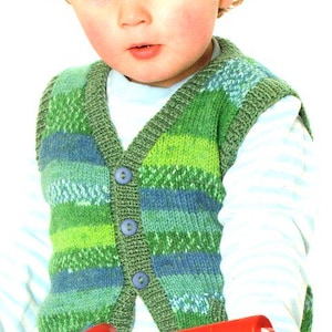 May include: A green and blue knitted vest with three blue buttons. The vest is worn over a white long-sleeved shirt with blue stripes. The child is holding a red object.