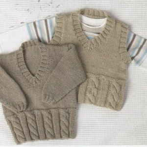 May include: Two knitted garments in a light brown color. One is a sweater with long sleeves and a v-neck. The other is a sleeveless vest with a v-neck and a cable knit pattern.