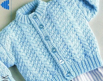 May include: A light blue knitted baby cardigan with a button closure. The cardigan is made with a textured stitch pattern and has a small boat in the background.