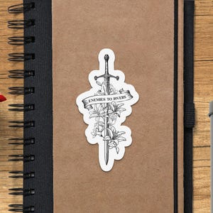 a notebook with a sticker of a sword on it