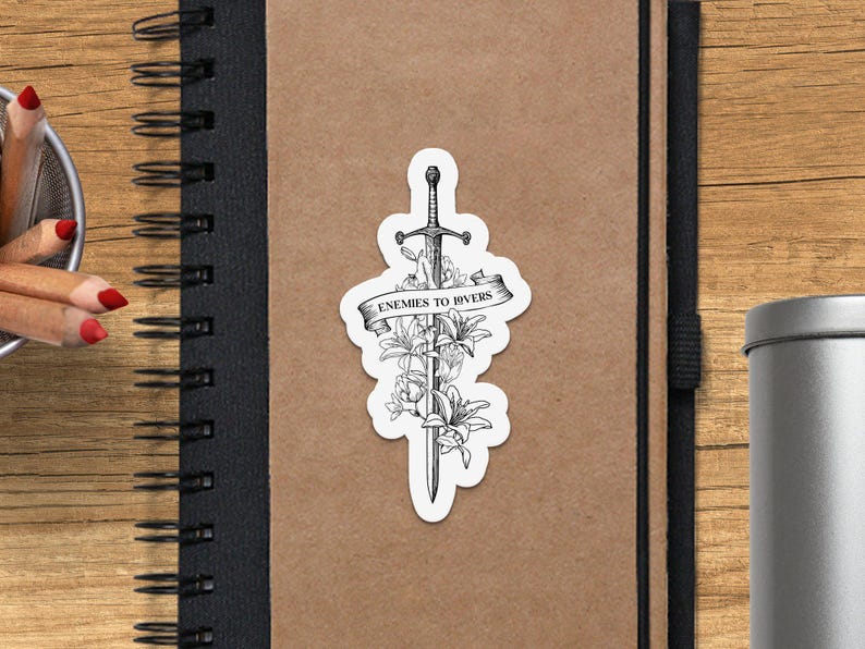 a notebook with a sticker of a sword on it