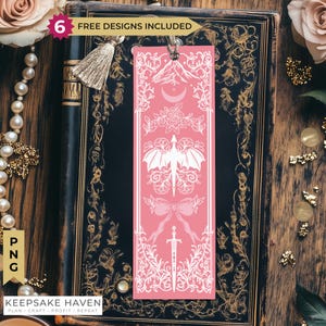 May include: A rectangular pink bookmark featuring white line art illustrations of a mountain, a crescent moon, a rose, a dragon with spread wings, a bow, and a sword. The bookmark includes a silver tassel at the top and the text 6 FREE DESIGNS INCLUDED.