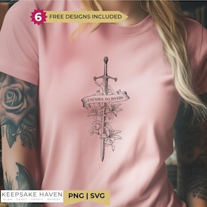 A person wearing a pink t-shirt with a graphic design of a sword and floral elements.