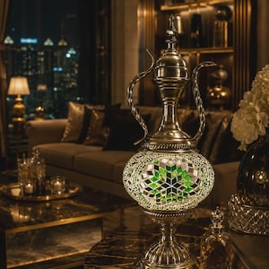 Peut inclure: Une lampe décorative en métal en forme de pichet traditionnel, dotée d'un corps bombé recouvert d'une mosaïque de carreaux de verre verts et transparents disposés en étoile, sur une base circulaire avec un col fin et un couvercle pointu.